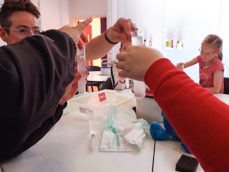 Young people at a table together conducting an experiment.